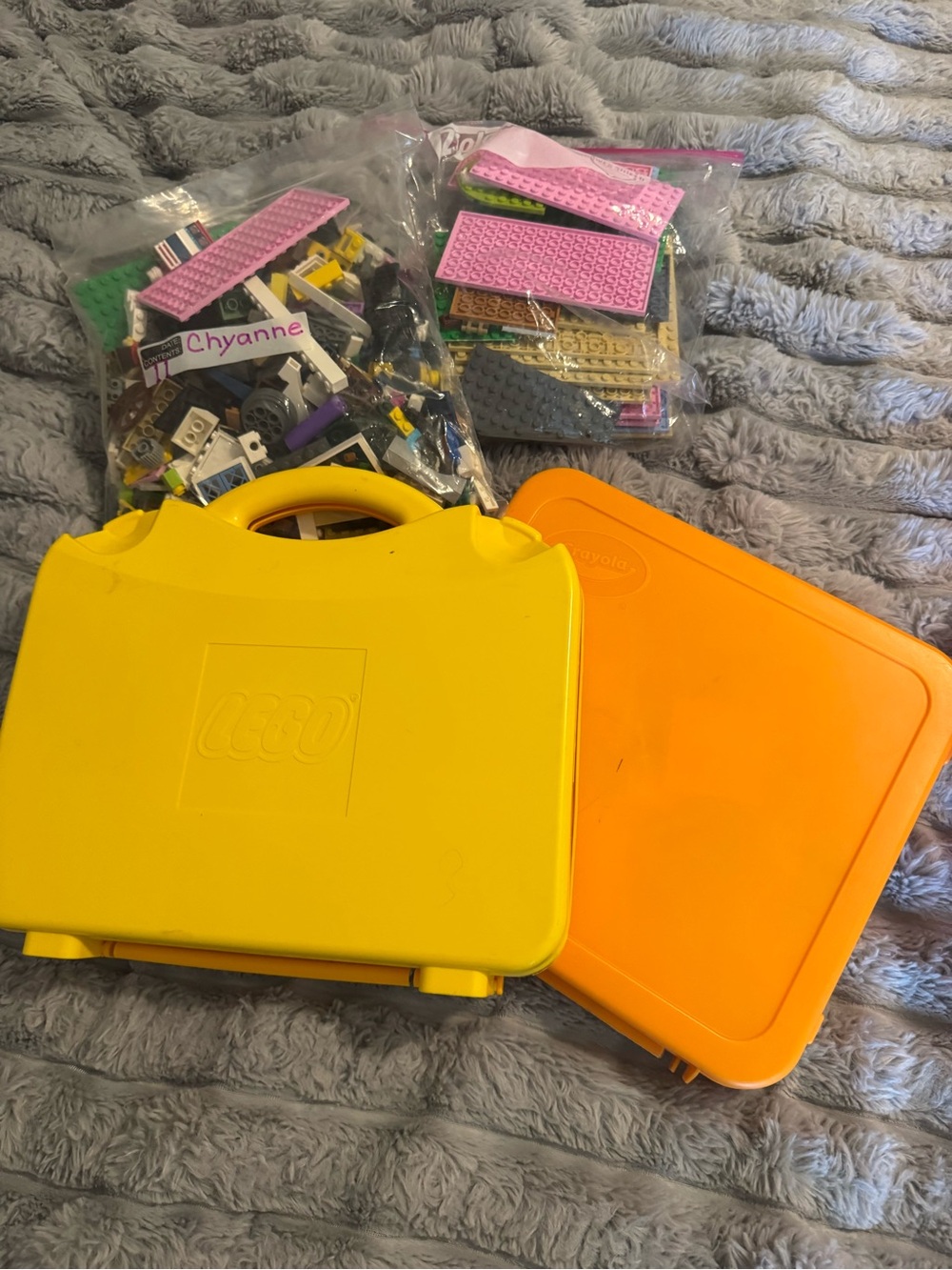 Lego Yellow and Orange Carry Cases filled with Lego bricks and a bag of boards